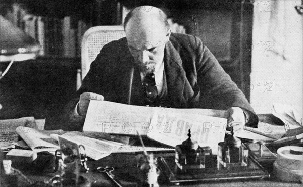 Lenin in his office in the Kremlin, reading Pravda. 1921