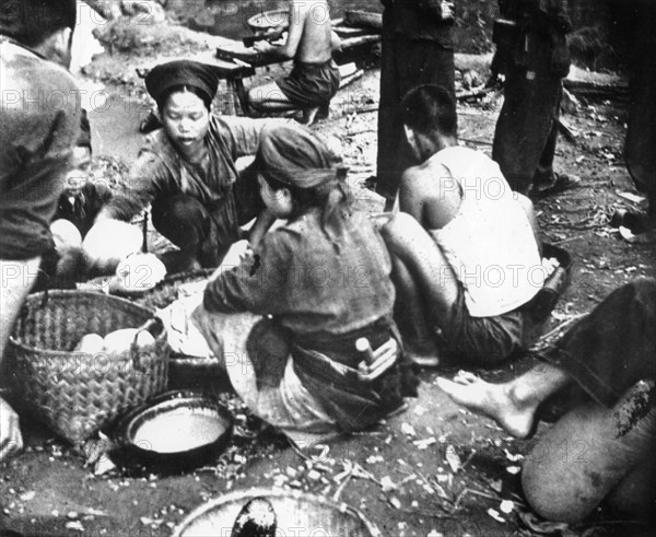 Conscripted labourers prepare rice balls