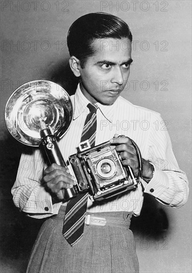 Satayan as staff photographer of Deccan Herald using a Speed Graphic press camera