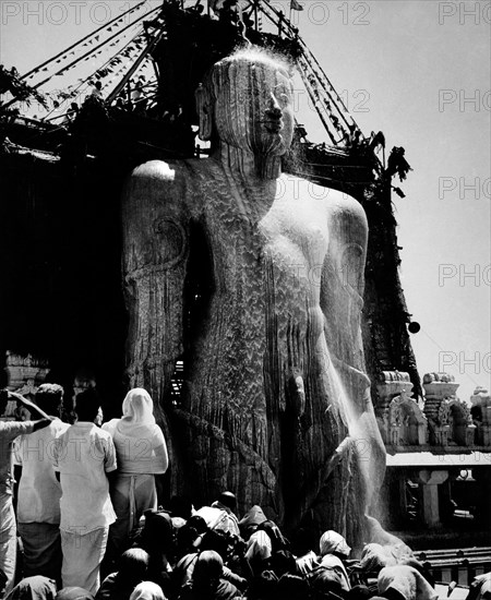 The gigantic statue of jain Gomateshvara Bahubali being bath in milk during the mahamastakabhisheka (the great anointing) festival