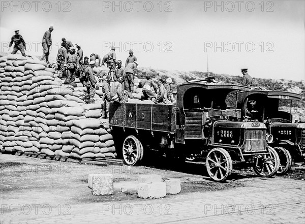 Magic Lantern Slide depicting men of the Chinese Labour Corps stacking sacks of corn at Boulogne during World War 1; Boulogne
