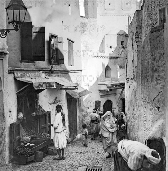 A street scene in Algiers with an Arab shop