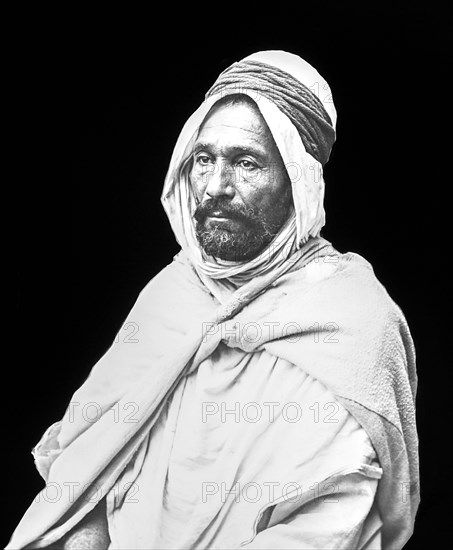 Black and white image of an Arab man against a black background; Algiers