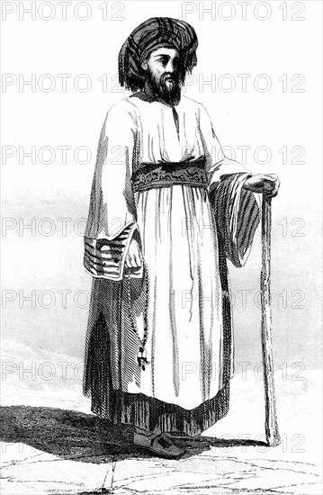 Native christian of betlehem, palestine. here is a portrait of religious man standing in the nativity square near the church of the city past. 1868