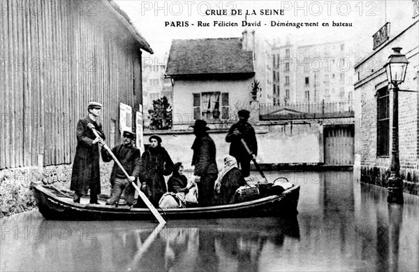 Flood in paris in 1910, removal by boat in félicien david street, . it was a catastrophe in which the seine river carried winter rains. the level rose eight meter above normal. 1910 flood in paris in 1910