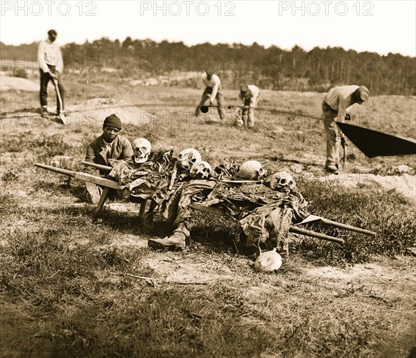 African Americans collecting bones of soldiers killed in the battle