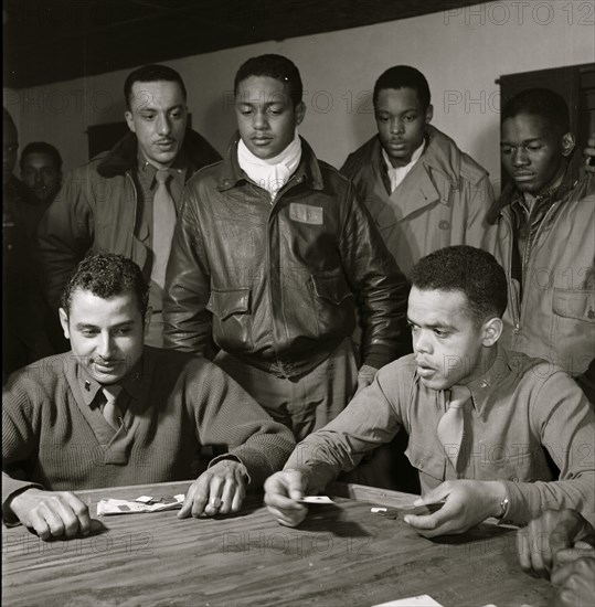 Tuskegee airmen playing cards in the officers' club in the evening