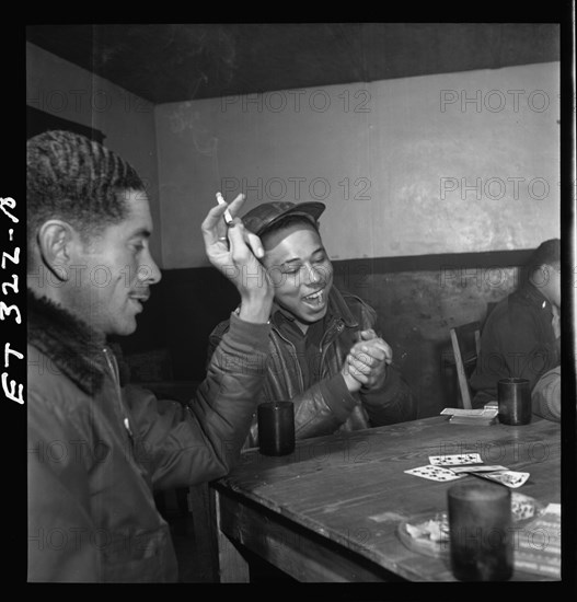 Tuskegee airmen playing cards in the officers' club in the evening