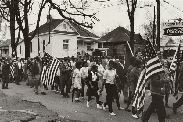 Participants, some carrying American flags, marching in the civil rights march from Selma to Montgomery, Alabama in 1965