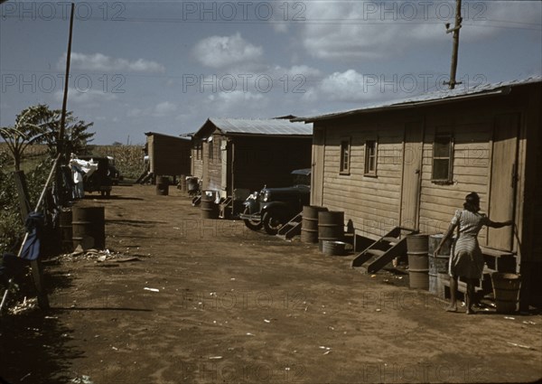 Negro migratory workers by a shack, Belle Glade,