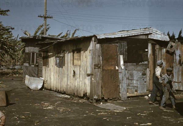 Negro migratory workers by a shack, Belle Glade,