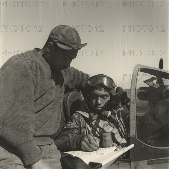 Pilot from the 332nd Fighter Group signing Form One Book