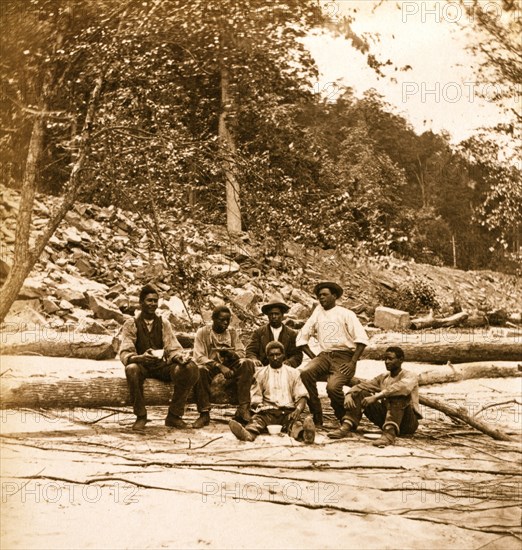 Capt. Ed. Armstrong (Colored) & crew of bateau Tam O'Shanter on beach of New River,