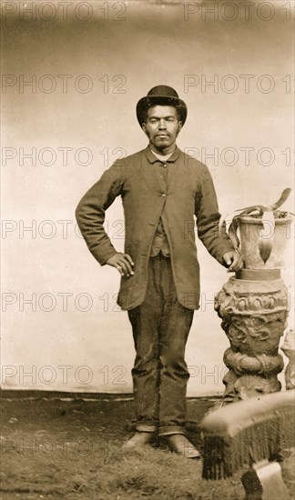 Portrait of an African American man standing by Plant