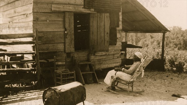 Old Aunt Julia Ann Jackson, age 102 and the corn crib where she lives