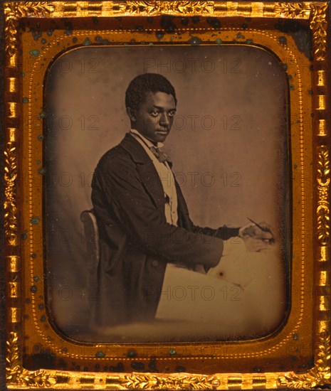 James B. Yates, three-quarter length portrait, three-quarters view, seated in chair at desk