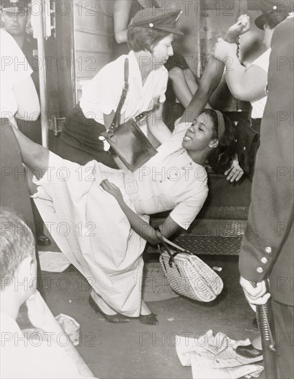 African American woman being carried to police patrol wagon