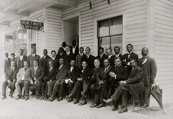 Booker T. Washington seated with group of men
