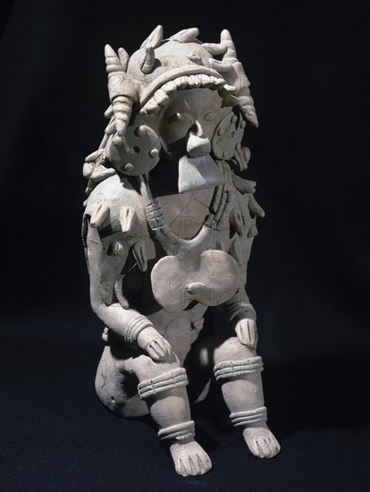 Male figure sitting.