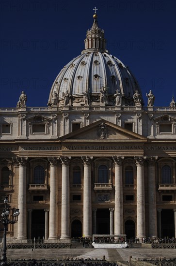 Tourists in St. Peters Square and Basilica of St. Peters.