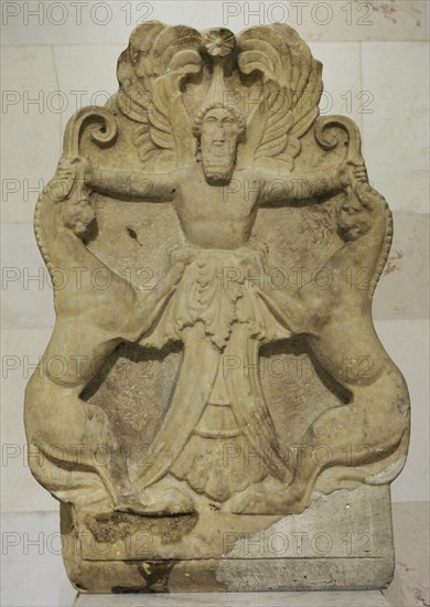 Acroterium with a relief depicting Arimaspian (winged-deity) holding griffins by their horns.