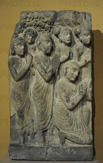 Monks and laymen from a scene of the Buddha sermon.