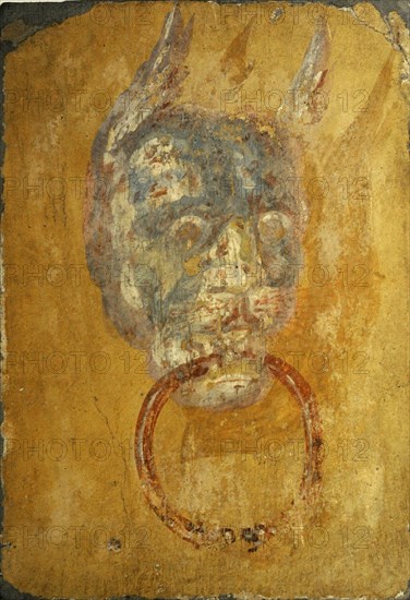 Roman fresco depicting a door frame with a monstrous head.