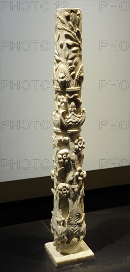 Roman column with flowering branches, swans with deployed wings, dolphins, baskets of fruit, theater masks and olive branches.