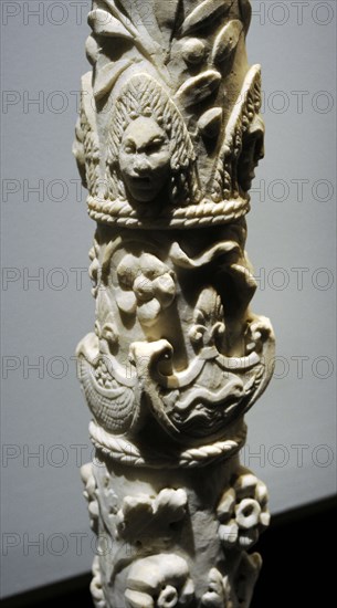 Roman column with flowering branches, swans with deployed wings, dolphins, baskets of fruit, theater masks and olive branches.