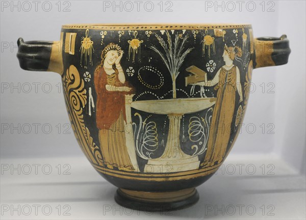 Pyxis depicting two women in a toilette next to a louterion.