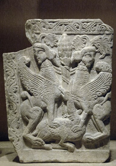 Tree of life between two sphinxes treading a deer.