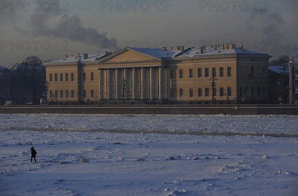 Person walking on the frozen Neva river during the winter surface.