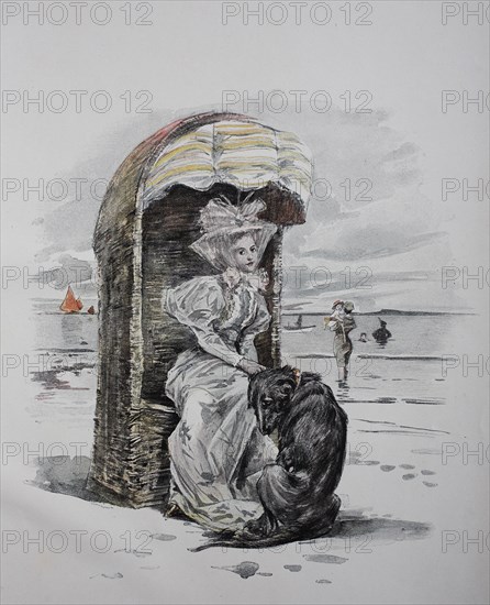 Woman and dog in beach chair on the North Sea