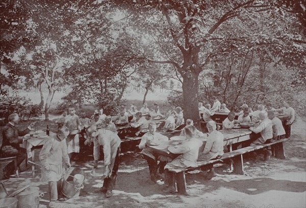 Orphans in Berlin having lunch in the garden