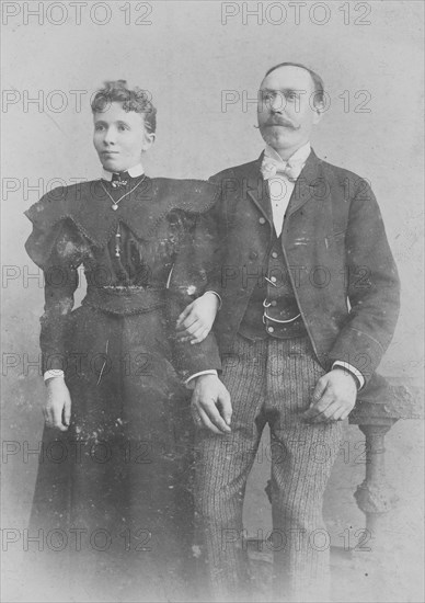 elderly couple in Sunday clothes at the photographer