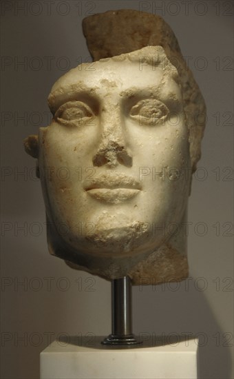 Head of young man with helmet, c