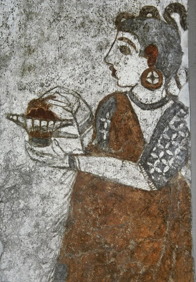 Priestess making offerings.