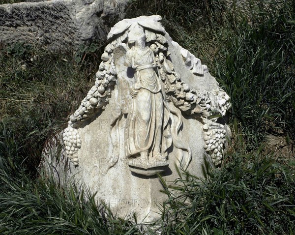 Fragment of a Roman sarcophagus. Winged female figure with a garland.