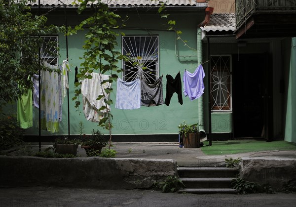 Interior of a typical yard of a house with laundry clothes drying.