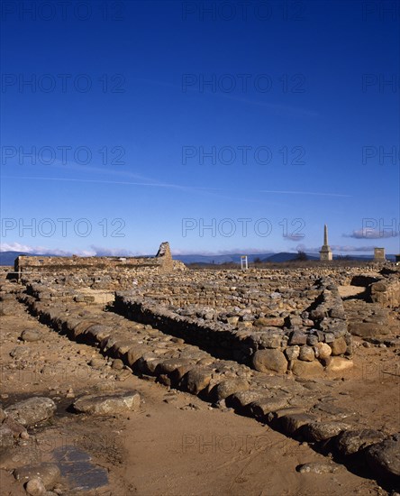 Ruins of houses with arcaded courtyards.