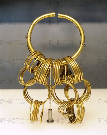 Gold bracelet with hanging spirals