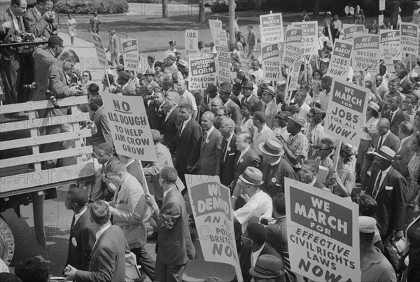 Photograph showing civil rights leaders, including Martin Luther King, Jr., surrounded by crowds carrying signs during the March on Washington. August 28, 1963. Photo by Warren K. Leffler.