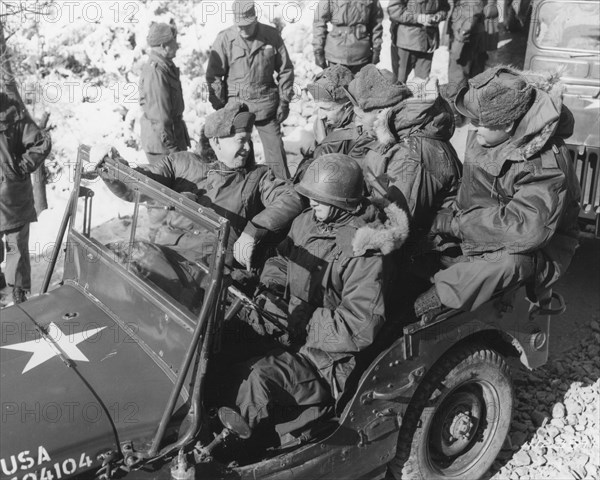 President-elect Dwight D. Eisenhower (front seat, left); General Mark W. Clark, Commander-in-Chief, United Nations Command (back seat, center), and members of their party begin a tour of installations in a jeep at the headquarters of the 2nd US Inf. Division. Korea, 12-5-52.