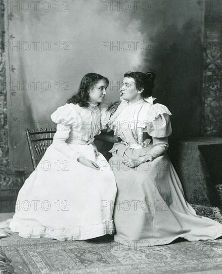 1897 - Deaf and Blind Helen Keller (left) 'listens' to Anne Sullivan's words in this photo. Anne Sullivan's brilliant success as Keller's teacher set standards for all who work with the deaf and blind.