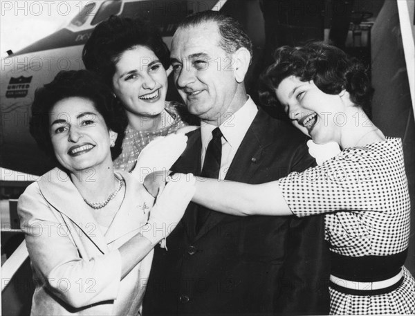 Senator Lyndon B. Johnson is embraced by his wife, Lady Bird (left) and their daughters Lynda (left) and Lucy (right). The Johnsons were on their way to the Democratic Convention in Los Angeles. 7-7-60.