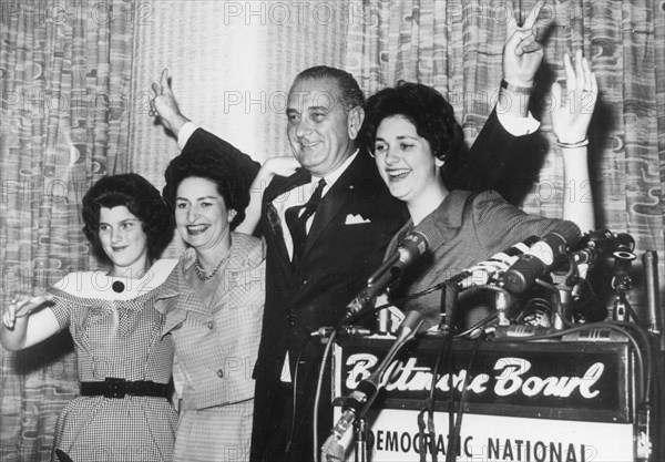 Senator Lyndon B. Johnson introduces his teen-aged daughters and wife to the audience at a press conference after his nomination to run as Vice-President on the Democratic ticket. Left to right: Lucy Baines, 13; Mrs. Johnson; and Lynda Byrd, 16. Los Angeles, July 8, 1960.