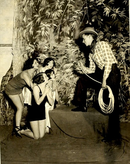 Circa 1920 - Dick Nash, the Will Rogers of Uncle Sam's Follies, looks over some 'ponies' he has just roped in.