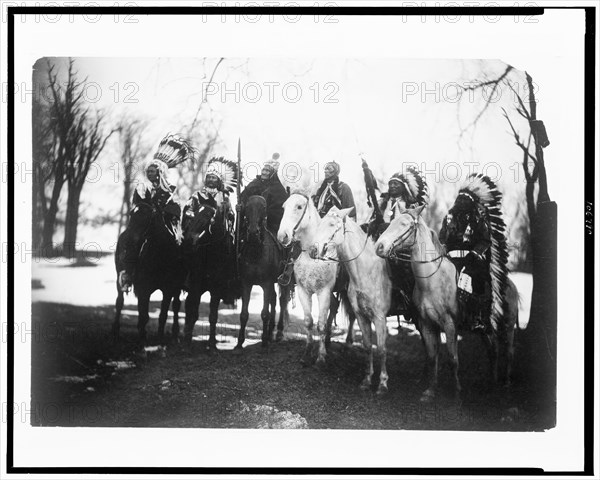 Circa 1900 - Six tribal leaders (l to r) Little Plume (Piegan), Buckskin Charley (Ute), Geronimo (Chiricahua Apache), Quanah Parker (Comanche), Hollow Horn Bear (Brulé Sioux), and American Horse (Oglala Sioux) on horseback in ceremonial attire.  Curtis, Edward S., 1868-1952, photographer