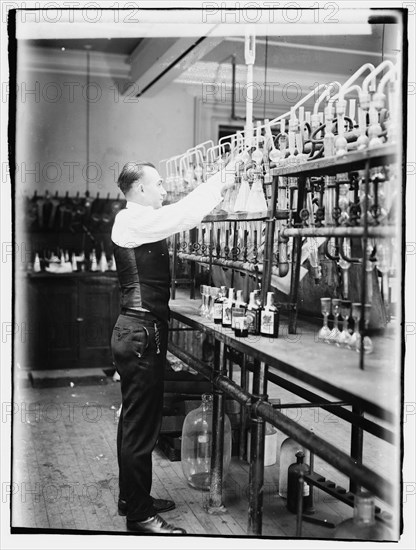 1920 -  Treasury, Internal Rev. Chemist G.F. Beyertesting bootleggers' booze.