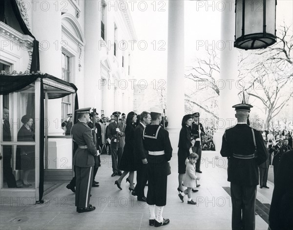 The Kennedy family leaves the White House to attend the brief service at the U.S. Capitol. President and Mrs. Johnson follow. Washington, DC, November 24, 1963. Abbie Rowe photographer.